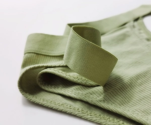 Detailed macro view of light green ribbed cotton fabric and high-elasticity waistband