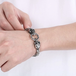 Punk retro skull steel bracelet with king chain design worn by model on wrist