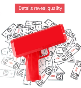 Detail showing the red electric money gun toy with play money on a white background