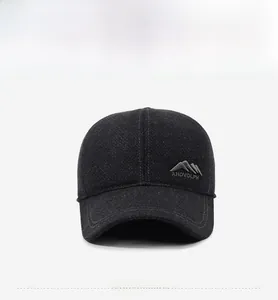 Close-up of grey wool baseball cap with mountain embroidery and ANDVOLPH logo detail