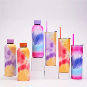 Detailed view of colorful tie-dye stainless steel tumblers and skinny bottles on white blocks