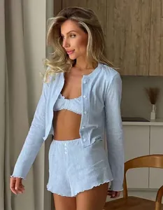 Detail of light blue knit pajamas featuring ribbed texture and single-breasted buttons