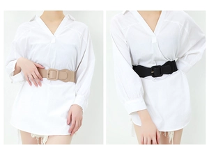 Contrast of beige and black elastic wide belts with square buckles on white dress