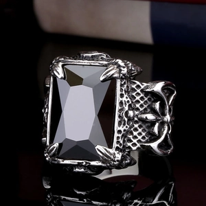 Macro shot of men's vintage gothic ring featuring a large black gemstone and aged steel