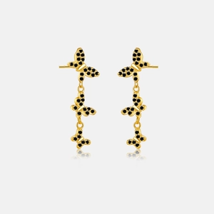 Macro detail of triple butterfly drop earrings in gold with pavé black stones and mirrors