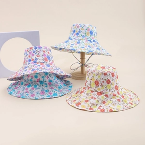 Floral cotton sun hat for children with wide wavy brim and adjustable neck straps
