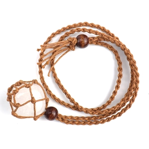 Detailed macro view of raw clear quartz crystal secured in a brown hand-woven net cord