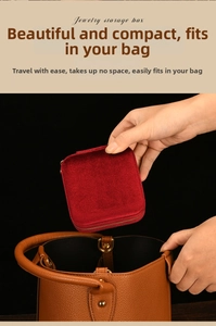Red velvet mini jewelry box being placed into a bag showing its portable travel size