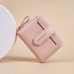 Pink pebbled leather wallet detail showing the card slots and baellerry buckle closure