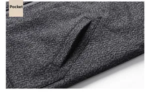 Detail of dark grey wool jacket featuring a reinforced side pocket and textured fabric