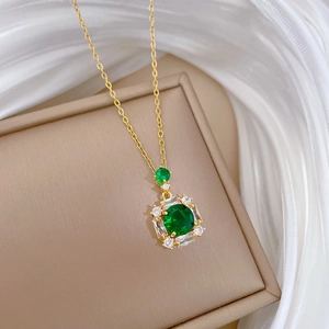 Detail of emerald green crystal pendant with micro-pave diamonds on golden necklace