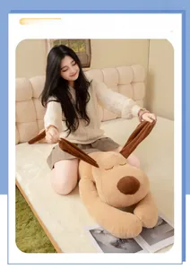 Detailed view of large plush dog pillow showing soft texture and long ears on cozy bed