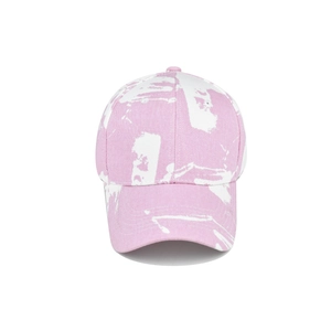 Detail of pink and white tie-dye baseball cap featuring twill fabric and marble texture
