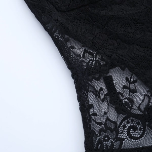 Detail of delicate black floral lace embroidery and sheer cut-out fabric on the dress