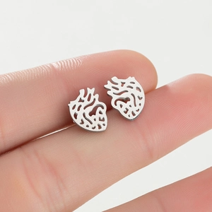 Macro shot of silver anatomic heart stud earrings showing hollow geometric design details