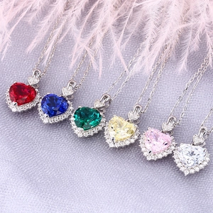 Macro shot of colorful heart gemstones with silver setting in varied vibrant colors