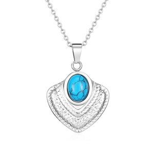 Detailed macro view of heart shaped silver necklace featuring a natural turquoise stone