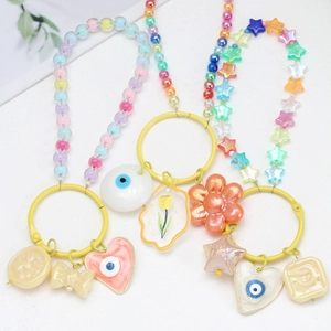 Detail of colorful evil eye keychains with good luck stars and tulip charms