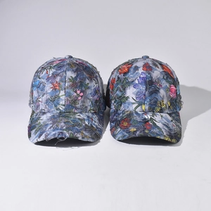 Two-pack of vintage denim baseball caps with floral patterns and distressed frayed brims
