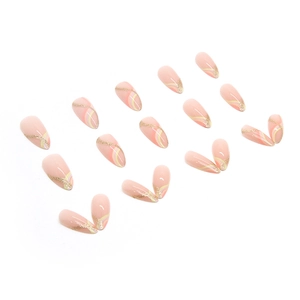Almond-shaped press-on nails with nude pink base, yellow swirls, and gold glitter accents