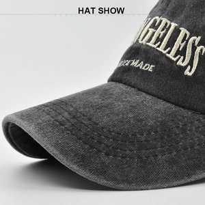 Close-up of white 3D embroidery and stitching details on dark gray baseball cap