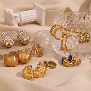 Detailed arrangement of 18K gold wave earrings with zircons and blue gemstones