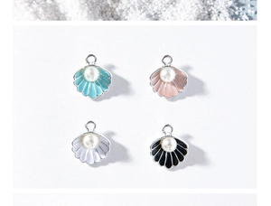 Detail view of shell charms with pearls in blue, pink, white, and black for DIY jewelry