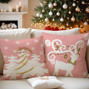 Detail of pink Christmas pillowcases featuring white reindeer, trees and JOY print