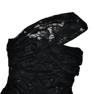 Close-up of black floral lace fabric with intricate stitching on backless leopard dress