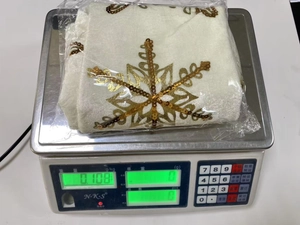 Detailed weight measurement showing white velvet Christmas stocking with gold snowflake