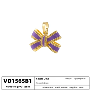 Detail view of brass bow pendant with purple enamel and pavé crystals, 17mm x 17.5mm