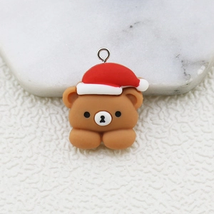 Macro view of a resin Christmas bear charm with a metal loop for DIY jewelry crafts