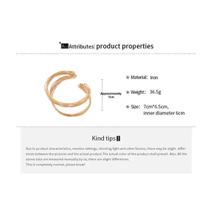 Detail view of twisted gold iron bangle showing 7cm height and multi-layer wire design