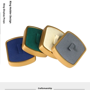 Detail of velvet lined metal ring display holders in blue, green, white and grey colors