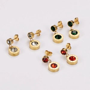 Three pairs of Roman numeral gold earrings set with clear, red, and emerald crystals