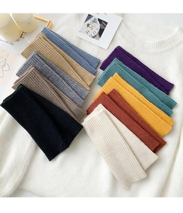 Detailed view of multi-color ribbed knit fingerless gloves and arm warmers set