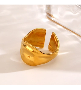 Close-up of a wide polished gold-plated geometric ring featuring an adjustable open band