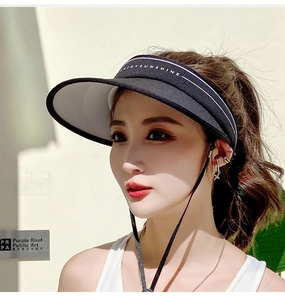 Detail of black visor hat with white ENJOYSUNSHINE embroidery and adjustable wind rope