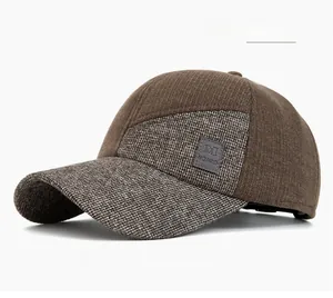 Detailed close-up of brown textured fabric and leather logo patch on winter baseball cap