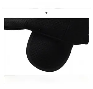Close-up of black knitted winter hat showing ear protection and fine grid texture details