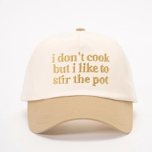 Two-tone beige baseball cap with 'i don't cook' embroidery and adjustable strap