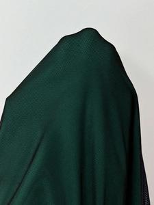 Detailed close-up of dark green breathable mesh fabric with a diamond grid structure