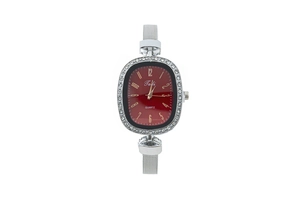 Detail view of red oval watch face with diamond-set bezel and silver mesh band