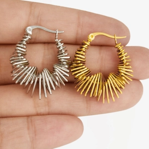 Macro shot showing hollow spiral spring hoops in silver and gold minimalist finishes