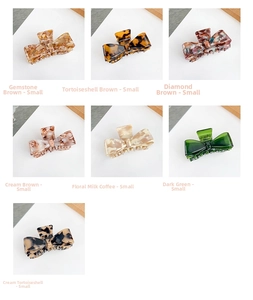 Detail of assorted small acetate bow hair claws in tortoiseshell and marble patterns
