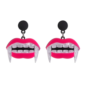 Detail view of pink acrylic vampire fang earrings with white shell texture for Halloween