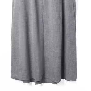 Close-up of gray woven fabric showing fine texture and hem detail of the skirt set