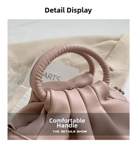 Detail of the elegant ruched handle on this dusty rose vintage style shoulder bag