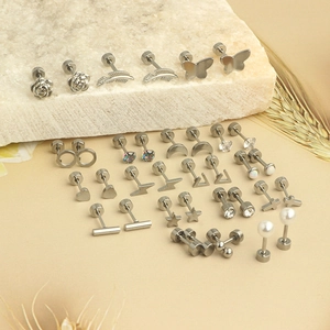 Detailed set of silver stainless steel piercing earrings with butterfly and star motifs