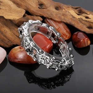 Detailed close-up of a punk-style lion head link chain bracelet in polished stainless steel